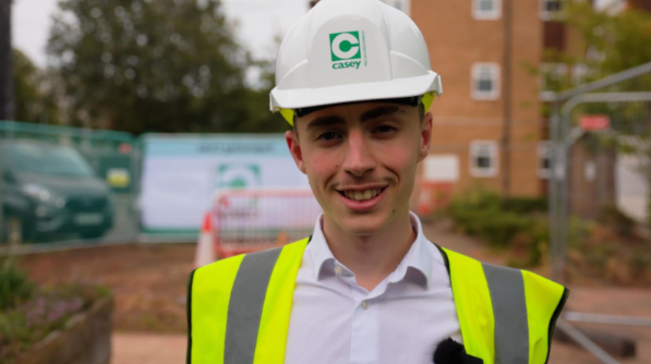 Billy wears a hard hat and high visibility jacket on site